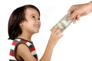 Boy receiving money from adult